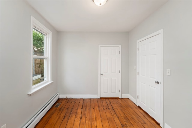 65 Lancaster St Unit 1, Providence, RI 02906 - unfurnished bedroom featuring a baseboard radiator and hardwood / wood-style flooring