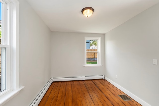 65 Lancaster St Unit 1, Providence, RI 02906 - spare room featuring a baseboard heating unit and hardwood / wood-style flooring