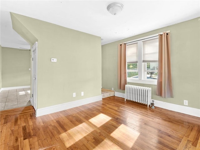 124 Everleth Ave, Warwick, RI 02888 - empty room featuring radiator and hardwood / wood-style floors