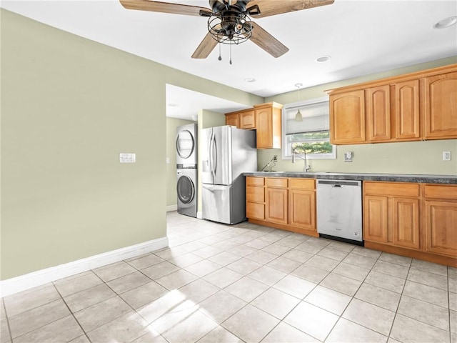 124 Everleth Ave, Warwick, RI 02888 - kitchen featuring appliances with stainless steel finishes, stacked washer and clothes dryer, a ceiling fan, light tile patterned floors, and dark countertops