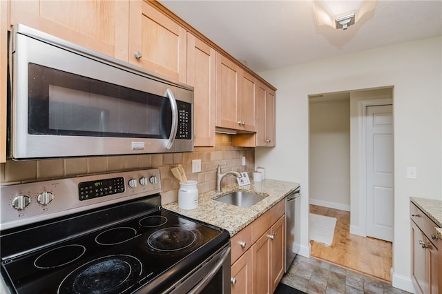 25 Bullocks Poing Ave Unit 3A, East Providence, RI 02915 - kitchen featuring stainless steel appliances, decorative backsplash, light stone counters, and light brown cabinets