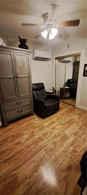 26 Morton Ave, Johnston, RI 02919 - living room featuring an AC wall unit, a ceiling fan, and light wood-style floors