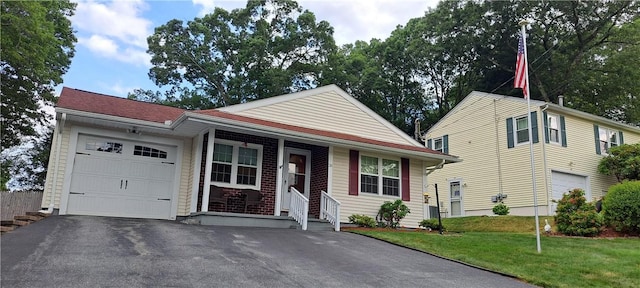 26 Morton Ave, Johnston, RI 02919 - view of front of house with asphalt driveway, a garage, and a front yard