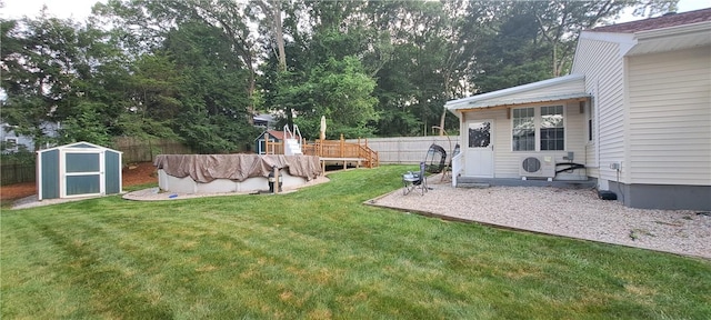 26 Morton Ave, Johnston, RI 02919 - fenced backyard featuring a storage shed and view of wooded area