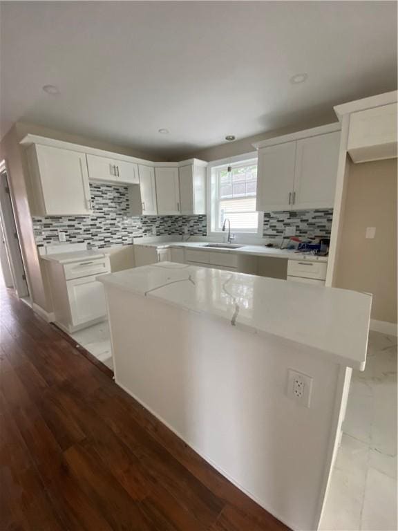 4 Halton St, Providence, RI 02907 - kitchen featuring tasteful backsplash, white cabinetry, a kitchen island, light countertops, and recessed lighting