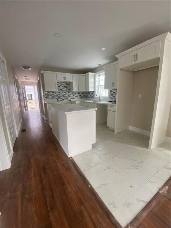 4 Halton St, Providence, RI 02907 - kitchen with white cabinetry, backsplash, light countertops, a kitchen island, and recessed lighting