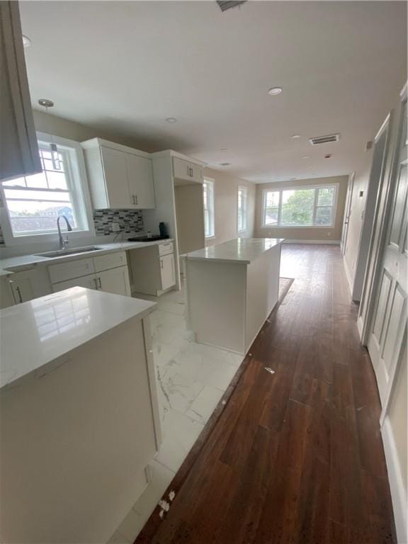 4 Halton St, Providence, RI 02907 - kitchen featuring recessed lighting, backsplash, white cabinetry, a center island, and light countertops