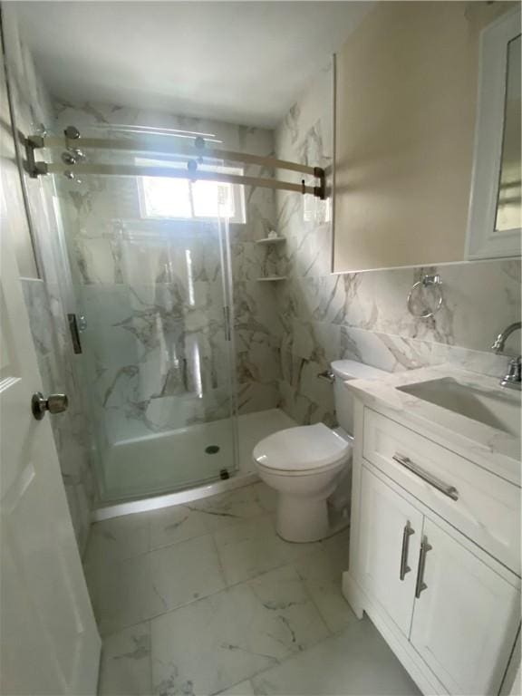 4 Halton St, Providence, RI 02907 - bathroom featuring a marble finish shower, vanity, marble look tiles, and tile walls