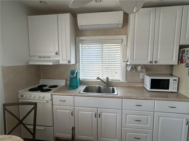 854 Matunuck Beach Rd, South Kingstown, RI 02879 - kitchen with white appliances, under cabinet range hood, an AC wall unit, and white cabinetry