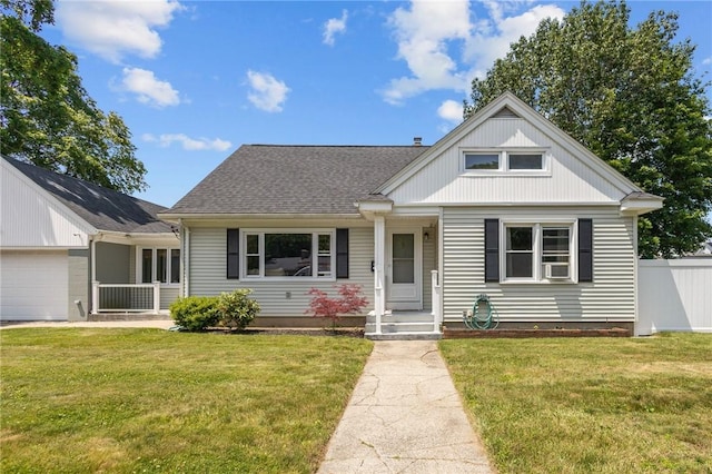 58 E St, West Warwick, RI 02893 - bungalow-style house with an attached garage, cooling unit, and a shingled roof