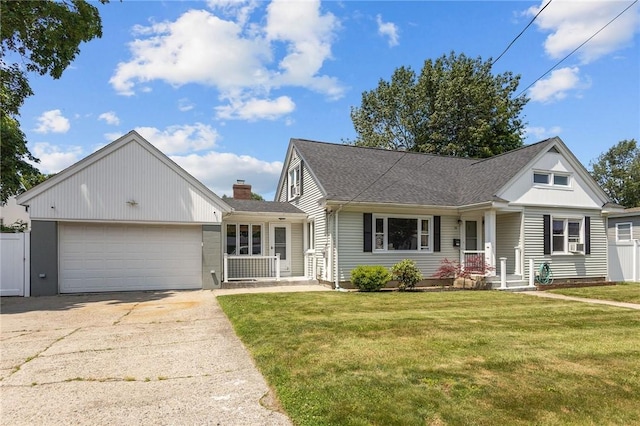 58 E St, West Warwick, RI 02893 - view of front of house featuring a garage, concrete driveway, and a front yard