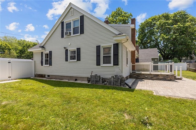 58 E St, West Warwick, RI 02893 - rear view of house with a chimney, a patio area, and a fenced backyard