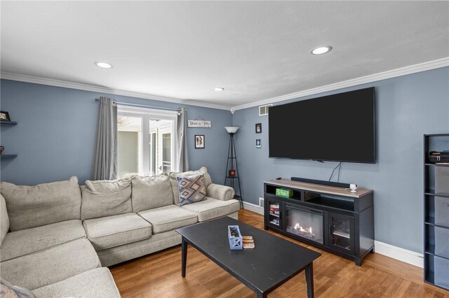58 E St, West Warwick, RI 02893 - living area featuring crown molding, wood finished floors, and recessed lighting