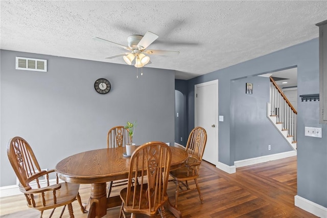 58 E St, West Warwick, RI 02893 - dining room with wood finished floors, a ceiling fan, stairs, and a textured ceiling