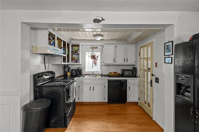 36 Dundas Ave, Warwick, RI 02889 - kitchen with black appliances, white cabinets, under cabinet range hood, light wood-style flooring, and open shelves