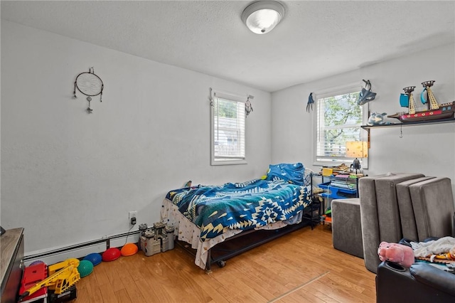 36 Dundas Ave, Warwick, RI 02889 - bedroom featuring a baseboard heating unit, multiple windows, and wood finished floors