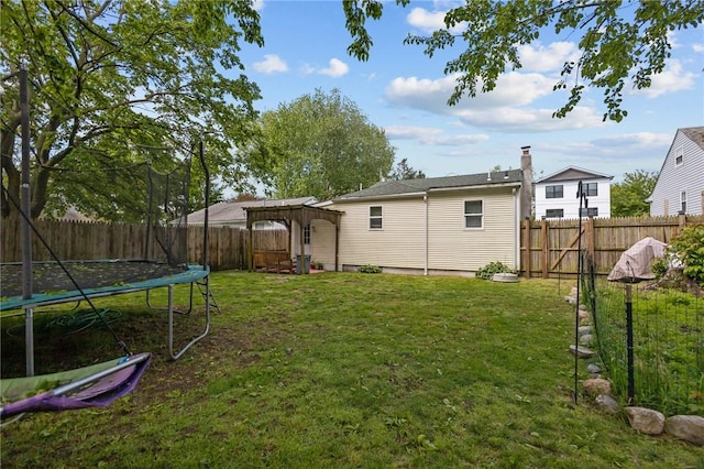 36 Dundas Ave, Warwick, RI 02889 - fenced backyard featuring a trampoline and a pergola