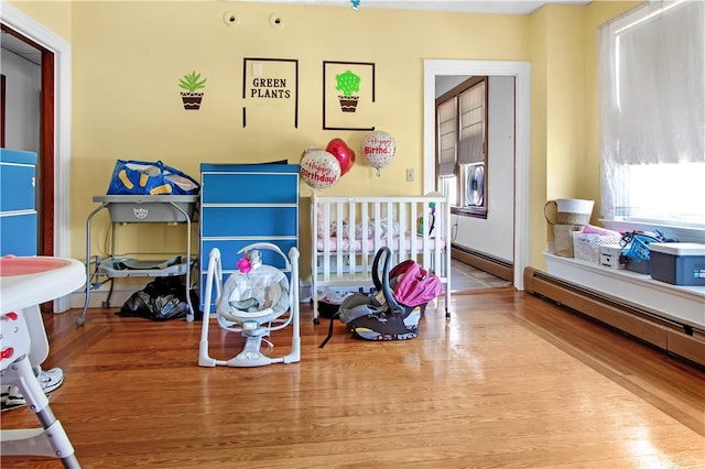 11 Branch Ave, Cranston, RI 02910 - bedroom with wood finished floors and a baseboard heating unit
