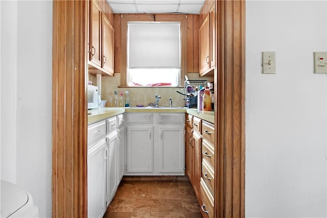 11 Branch Ave, Cranston, RI 02910 - kitchen featuring light countertops, tasteful backsplash, white microwave, a drop ceiling, and white cabinetry