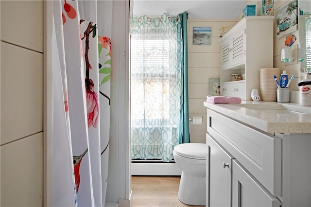 11 Branch Ave, Cranston, RI 02910 - bathroom with vanity, a baseboard heating unit, and wood finished floors