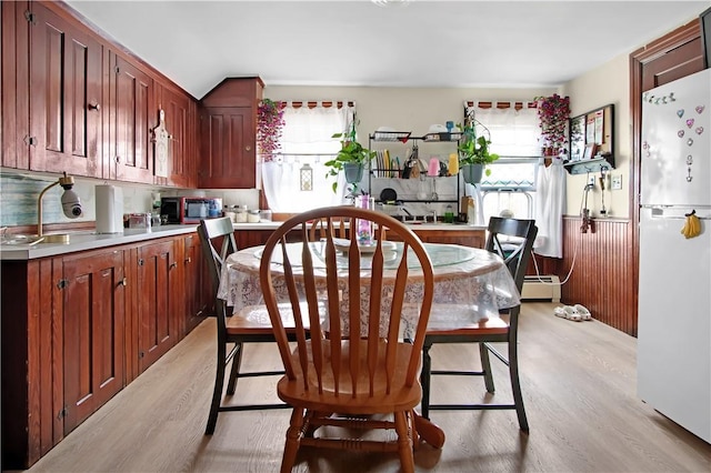 11 Branch Ave, Cranston, RI 02910 - dining area featuring light wood-style floors, a wainscoted wall, a baseboard heating unit, and vaulted ceiling