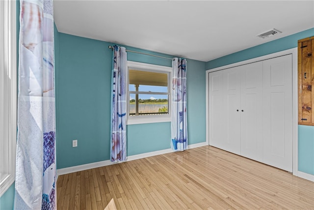 212 Round Pond Rd, Little Compton, RI 02837 - unfurnished bedroom featuring wood finished floors and a closet