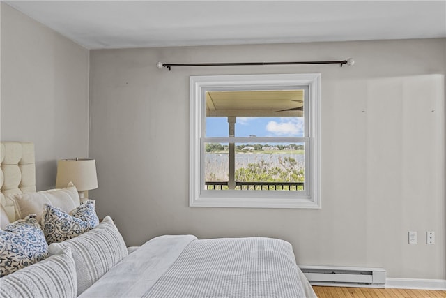 212 Round Pond Rd, Little Compton, RI 02837 - bedroom with a baseboard radiator and wood finished floors