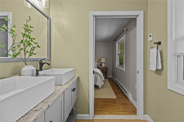 212 Round Pond Rd, Little Compton, RI 02837 - full bathroom featuring a baseboard heating unit, wood finished floors, and double vanity