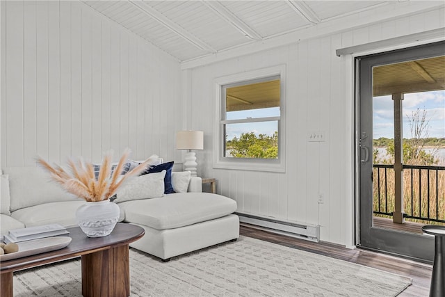 212 Round Pond Rd, Little Compton, RI 02837 - living room with baseboard heating, wood finished floors, plenty of natural light, and lofted ceiling