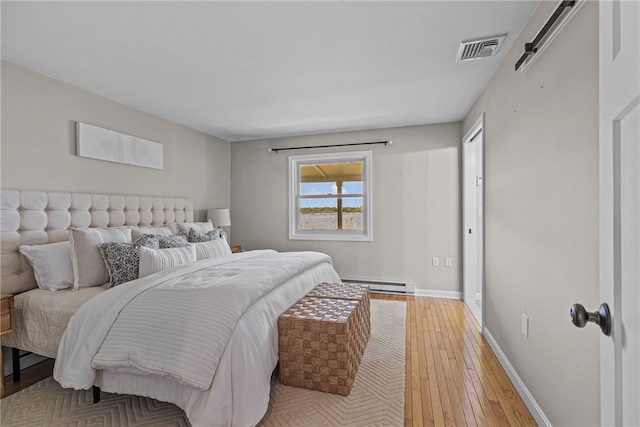 212 Round Pond Rd, Little Compton, RI 02837 - bedroom with baseboard heating and light wood-style flooring