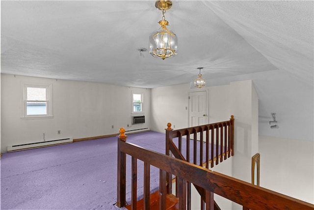 129 Academy Ave, Providence, RI 02908 - corridor featuring a baseboard heating unit, healthy amount of natural light, a chandelier, and a textured ceiling