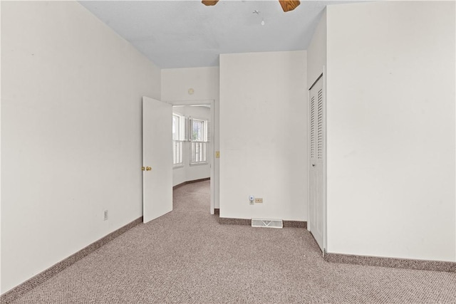 129 Academy Ave, Providence, RI 02908 - unfurnished bedroom featuring carpet, a closet, and a ceiling fan