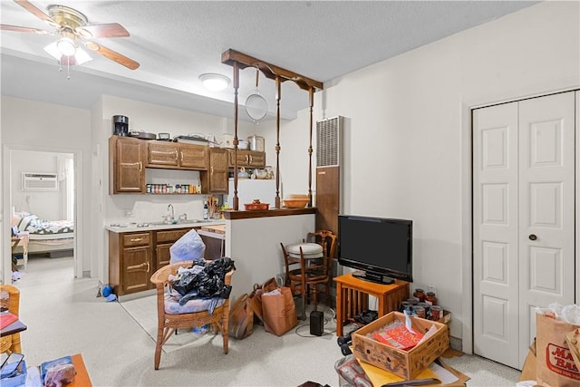 129 Academy Ave, Providence, RI 02908 - living area with a wall mounted AC, a ceiling fan, and a textured ceiling