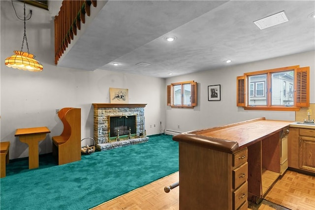129 Academy Ave, Providence, RI 02908 - kitchen with recessed lighting, a fireplace with raised hearth, brown cabinets, and open floor plan