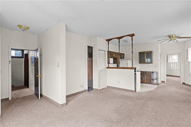 129 Academy Ave, Providence, RI 02908 - unfurnished living room featuring a heating unit, light colored carpet, and healthy amount of natural light
