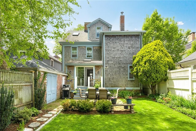 47 Second St, Newport, RI 02840 - back of property with a storage shed, a chimney, and a patio