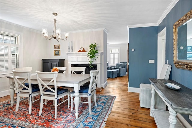 47 Second St, Newport, RI 02840 - dining space with a chandelier, hardwood / wood-style flooring, crown molding, and a fireplace