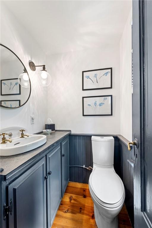 47 Second St, Newport, RI 02840 - half bathroom with vanity, wood finished floors, and wainscoting