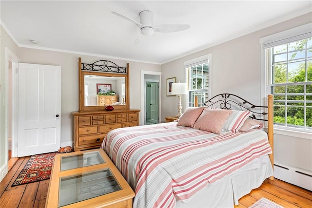 47 Second St, Newport, RI 02840 - bedroom with baseboard heating, light wood-type flooring, multiple windows, crown molding, and ceiling fan