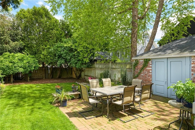 47 Second St, Newport, RI 02840 - fenced backyard featuring outdoor dining space, a storage unit, and a patio