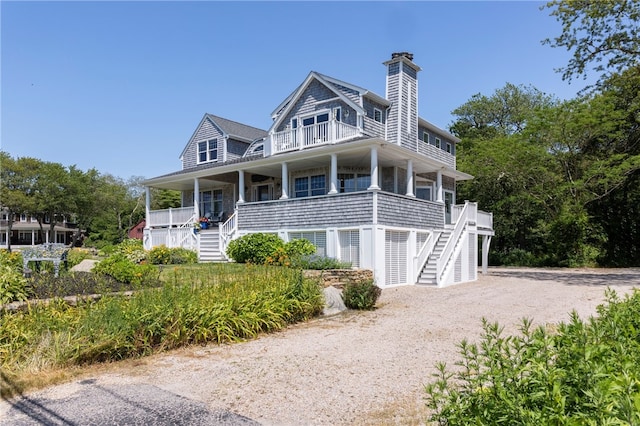 170 W Beach Rd, Charlestown, RI 02813 - view of front facade featuring stairs, a balcony, a chimney, and covered porch