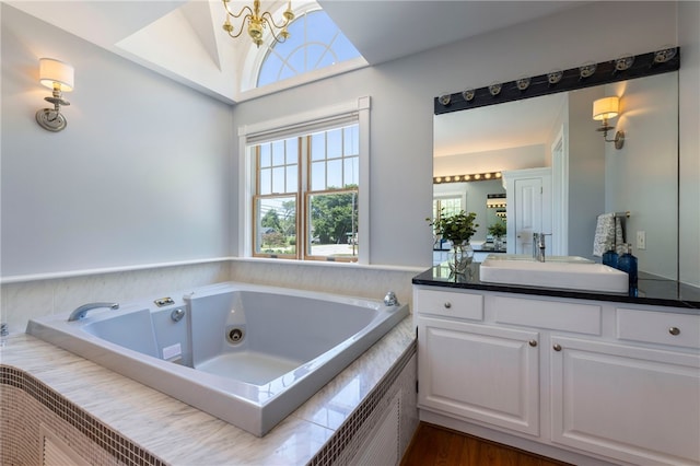170 W Beach Rd, Charlestown, RI 02813 - full bath featuring vanity, a jetted tub, vaulted ceiling, and wood finished floors