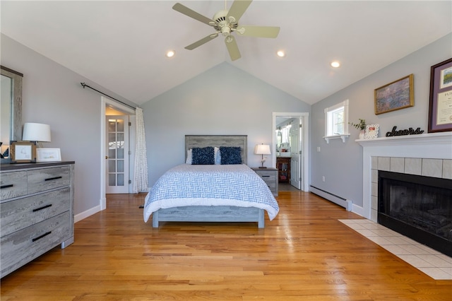 170 W Beach Rd, Charlestown, RI 02813 - bedroom featuring baseboard heating, vaulted ceiling, light wood-style flooring, recessed lighting, and a fireplace