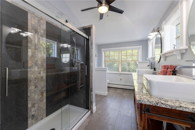 170 W Beach Rd, Charlestown, RI 02813 - bathroom with a baseboard heating unit, vaulted ceiling, a shower stall, double vanity, and ceiling fan