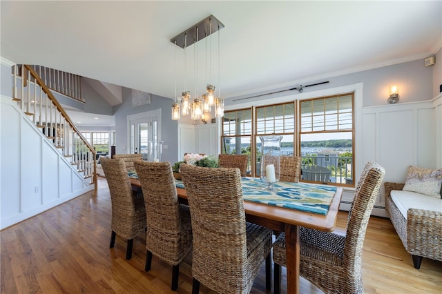 170 W Beach Rd, Charlestown, RI 02813 - dining space featuring a decorative wall, stairs, light wood-style flooring, a chandelier, and ornamental molding