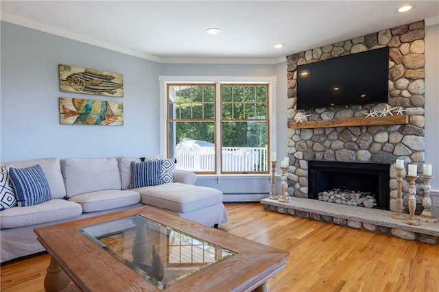 170 W Beach Rd, Charlestown, RI 02813 - living room featuring baseboard heating, ornamental molding, wood finished floors, and a stone fireplace