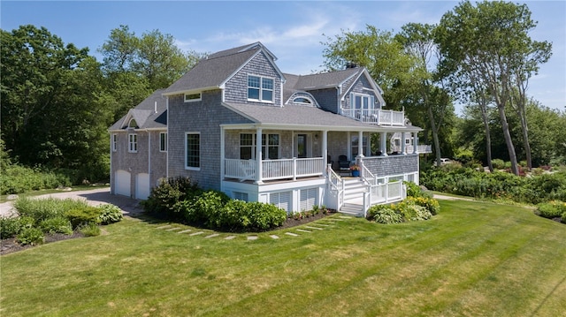 170 W Beach Rd, Charlestown, RI 02813 - view of front of house featuring a porch, an attached garage, a front yard, and a balcony