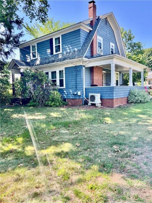 145 Olney Ave, North Providence, RI 02911 - back of property with a gambrel roof, a chimney, and a lawn
