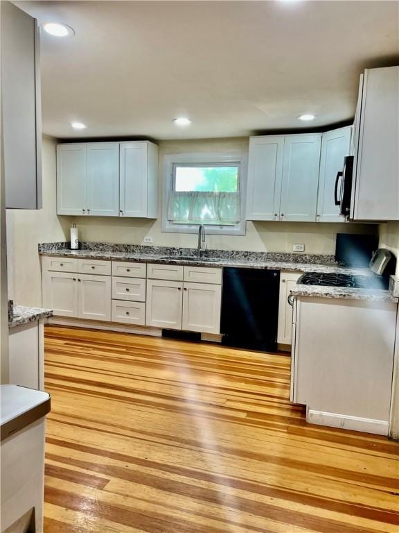 145 Olney Ave, North Providence, RI 02911 - kitchen featuring black dishwasher, stainless steel microwave, light wood-style floors, white cabinets, and recessed lighting