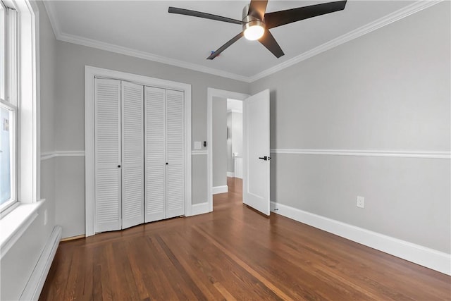 201 Bellman Ave, Warwick, RI 02889 - unfurnished bedroom with a baseboard heating unit, wood finished floors, a closet, ornamental molding, and ceiling fan